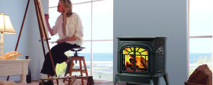 Woman painting in beach side house with gas stove