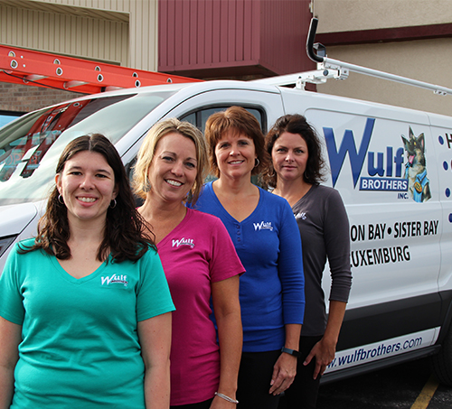 Support staff smiling next to van, Amanda, Holly, Lisa and Shirelle.